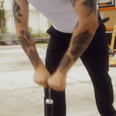 Man With Arm Tattoo Holding Microphone GIF