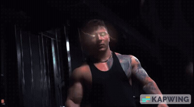 Man With Arm Tattoo Looking At Camera GIF