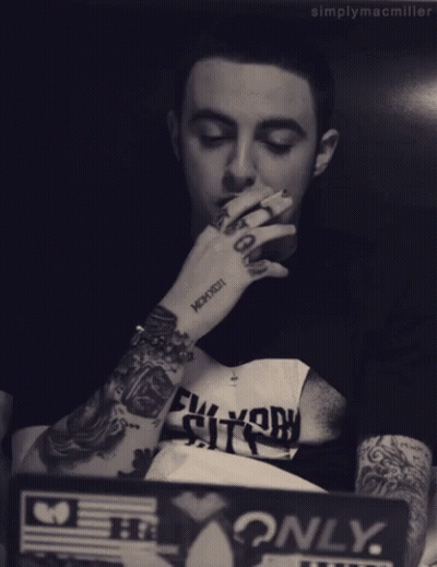 Man With Arm Tattoo Saying Mcmxcxii GIF