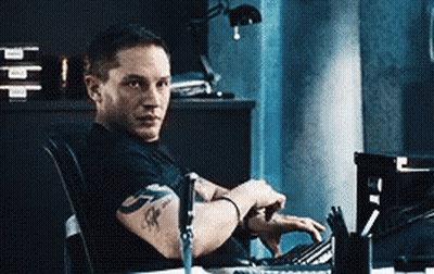 Man With Arm Tattoo Sitting At Computer GIF
