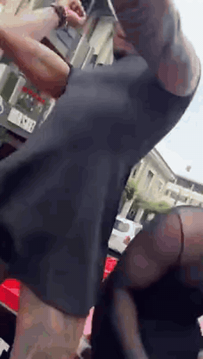 Man With Arm Tattoo Standing In Front Of Building GIF