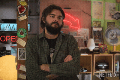 Man With Arms Crossed By Open Neon Sign GIF