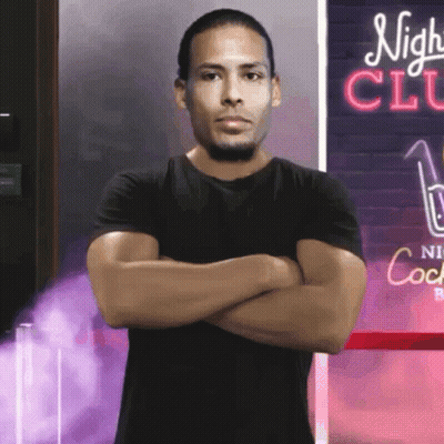 Man With Arms Crossed In Front Of Night Club Sign GIF