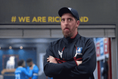 Man With Arms Crossed In Front Of We Are Richland Sign GIF