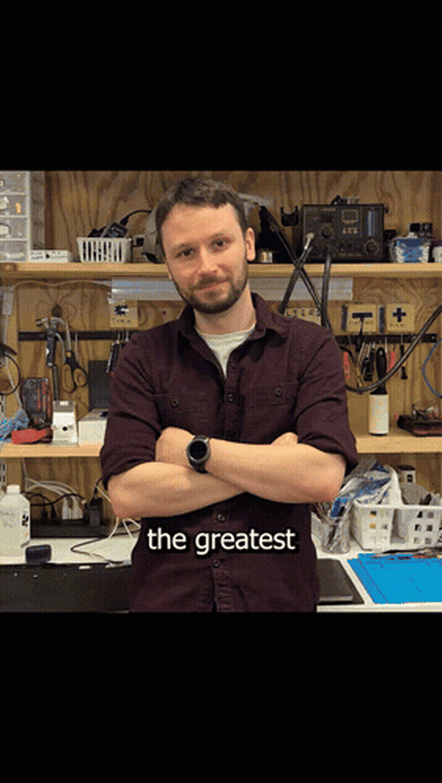 Man With Arms Crossed In Front Of Workbench Saying The Greatest GIF