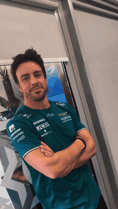 Man With Arms Crossed In Green JCB Shirt GIF