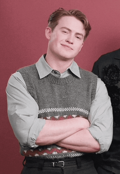 Man With Arms Crossed In Grey Vest GIF