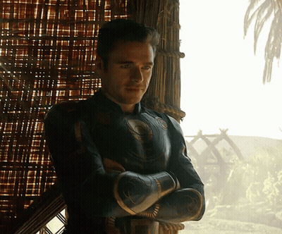 Man With Arms Crossed Standing In Front Of Window GIF