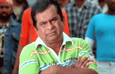 Man With Arms Crossed Wearing Green London Shirt GIF