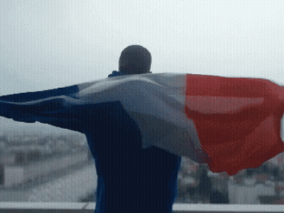 Man With Arms Outstretched Holding Flag GIF