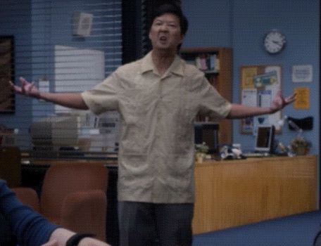 Man With Arms Outstretched In Front Of Clock GIF