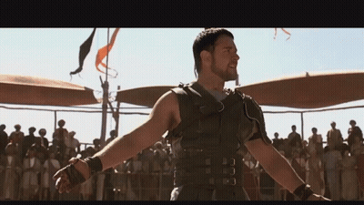 Man With Arms Outstretched In Front Of Crowd GIF