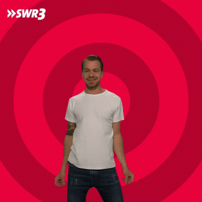 Man With Arms Outstretched In Front Of Red Circle GIF