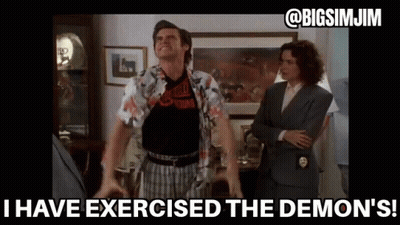 Man With Arms Outstretched In Living Room With Woman In Suit GIF
