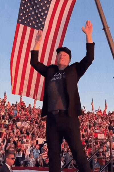 Man With Arms Up In Front Of American Flag GIF