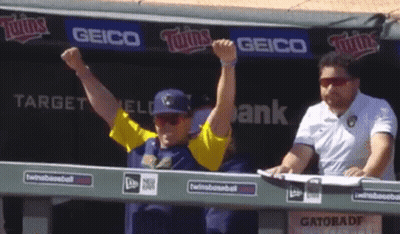Man With Arms Up In Front Of Geico Sign GIF