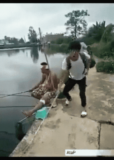 Man With Backpack Fishing In Lake, Another On Shore GIF