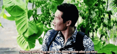 Man With Backpack Standing In Front Of Tree Talking GIF