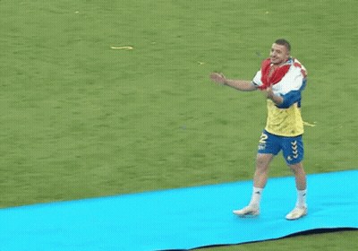 Man With Backpack Walking On Blue Mat GIF