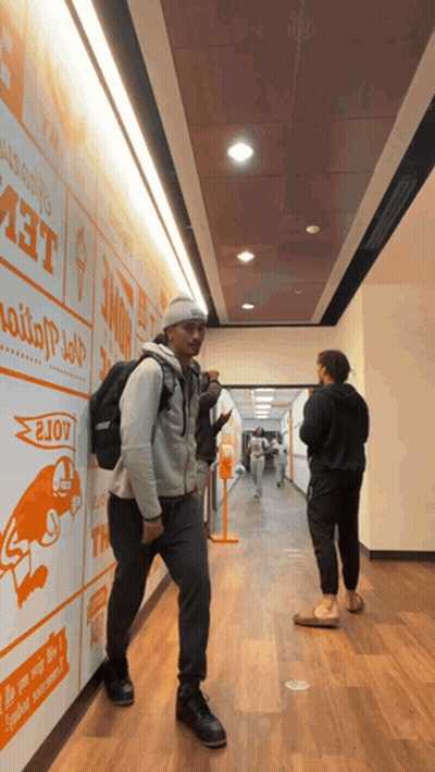 Man With Backpack Walking Past Home Wall GIF