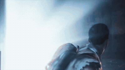 Man With Backpack Walking Through Dark Room GIF