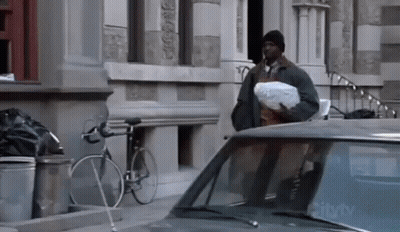 Man With Bag Standing Next To Car With CityTV On Windshield GIF