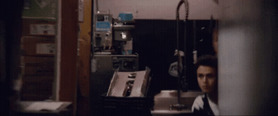 Man With Bandage On Arm Standing Next To Another Man GIF