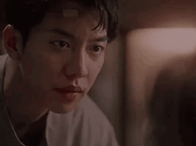 Man With Bandage On Forehead Looking At Camera GIF