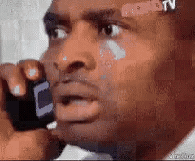 Man With Bandage On Forehead Talks On Cell Phone GIF