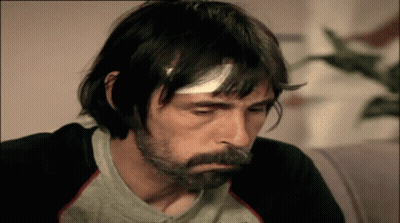 Man With Bandage On Head In Gray Shirt GIF