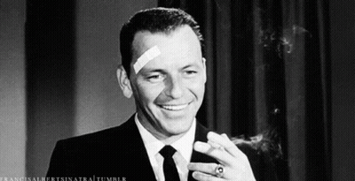 Man With Bandage Smiling And Smoking Cigar GIF