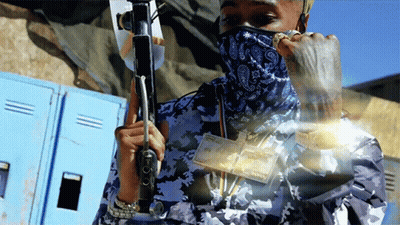 Man With Bandana Holding Gun And Money GIF