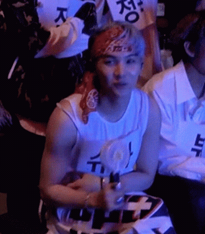 Man With Bandana Sitting In Crowd GIF