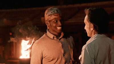Man With Bandana Talking By Fireplace GIF