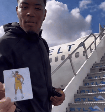 Man With Basketball Player Card In Front Of Jet GIF
