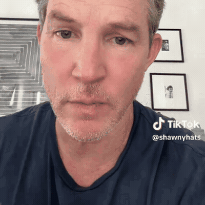 Man With Beard And Blue Shirt Has TikTok Sticker On Face GIF