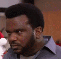 Man With Beard And Blue Shirt Looking At Camera GIF