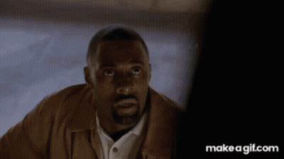Man With Beard And Brown Jacket Looking At Camera GIF