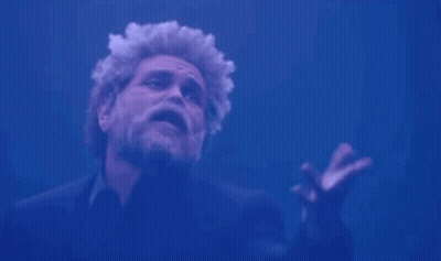 Man With Beard And Curly Hair Arms Outstretched Blue Background GIF
