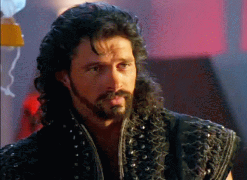 Man With Beard And Curly Hair In Black Vest GIF