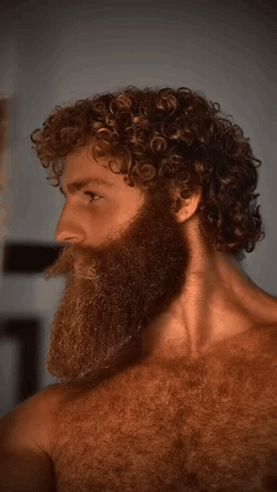 Man With Beard And Curly Hair Looking Sideways GIF