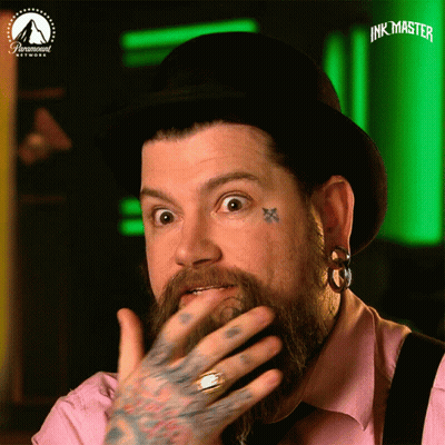 Man With Beard And Face Tattoos Wearing Paramount Hat GIF