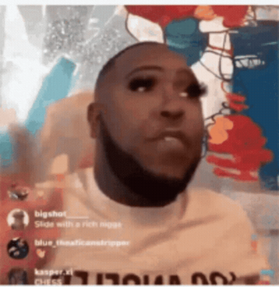 Man With Beard And Fake Eyelashes Before Colorful Wall GIF