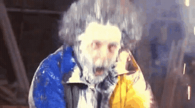Man With Beard And Frozen Hair In Blue And Yellow Jacket GIF