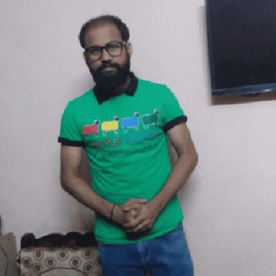 Man With Beard And Glasses In Green Shirt Saying United Colors Of Benetton GIF
