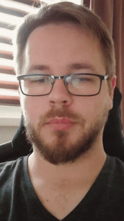 Man With Beard And Glasses Looking At Camera GIF