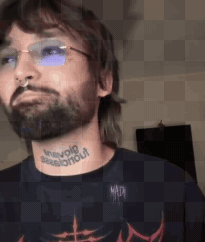 Man With Beard And Glasses Tattoo Saying Inevole GIF