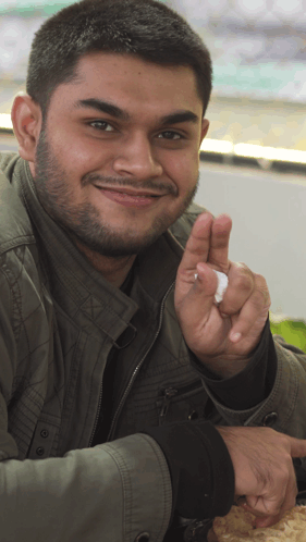 Man With Beard And Green Jacket Giving Peace Sign GIF