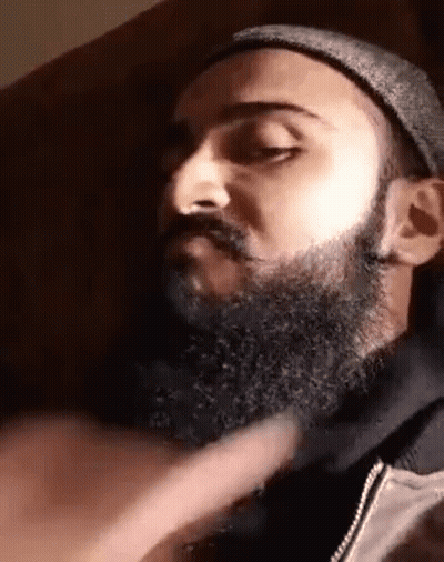 Man With Beard and Hat Eyes Closed on Couch