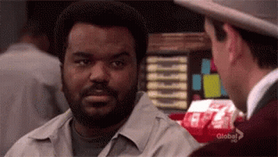 Man With Beard And Hat Talking To Another Man In Restaurant GIF